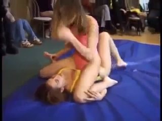 amateur match on a wrestling mat between two girls